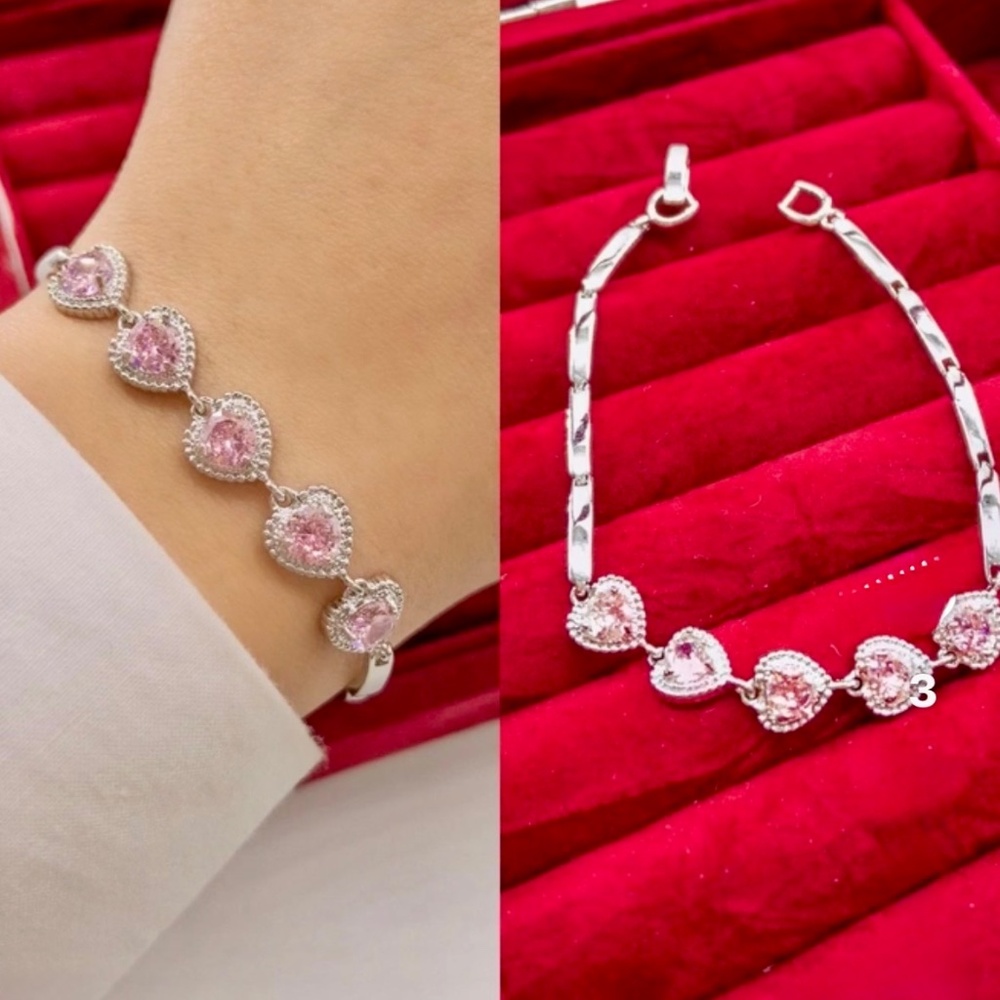 Girl’s silver-tone link bracelet with five pink crystal hearts in halo settings